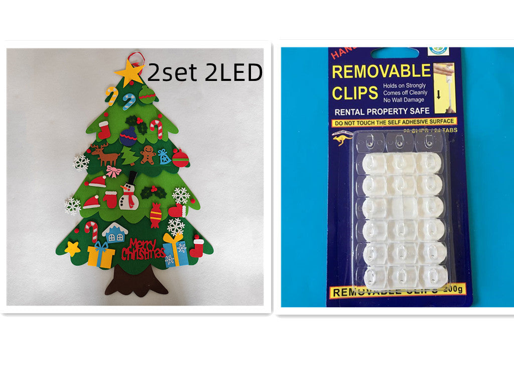 Felt Christmas tree with colorful ornaments and a "Merry Christmas" sign on the left. Pack of removable clips in blue packaging on the right.