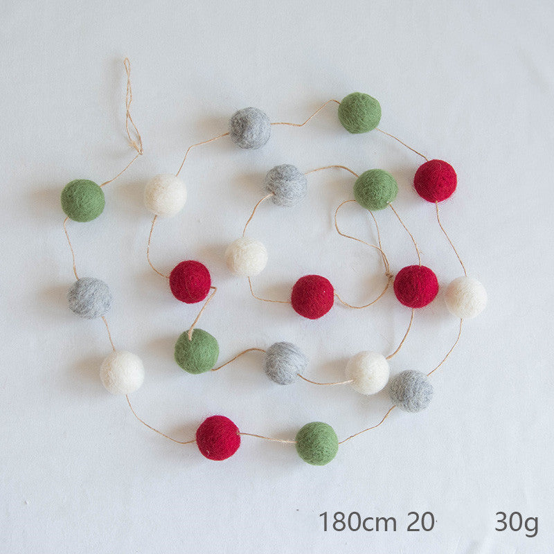 A string of felt balls in green, red, gray, and white lies on a white surface. The dimensions and weight are shown as 180 cm, 20 balls, and 30 g.