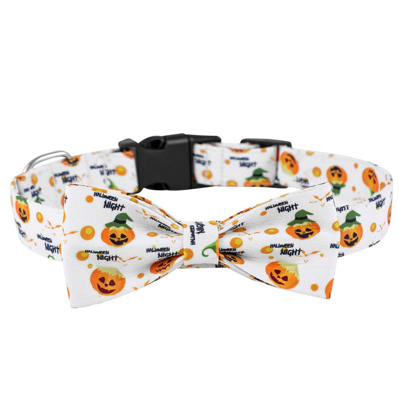 White pet collar with a Halloween theme, featuring jack-o'-lanterns and "Halloween Night" text, adorned with an attached matching bow tie and black plastic buckle.