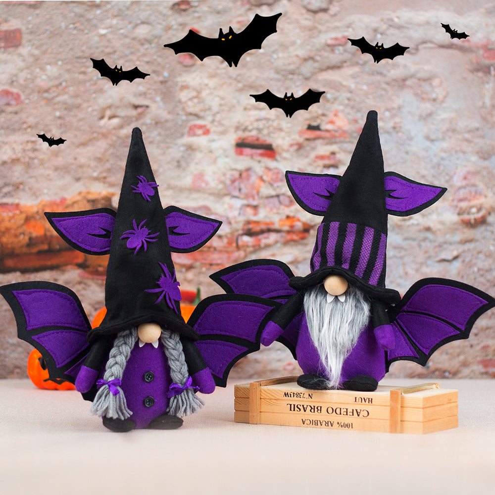 Two whimsical gnomes dressed in black and purple wizard costumes feature bat-winged hats. One has grey braids and spider embellishments. The other has a striped hat and a white beard. They stand against a brick wall backdrop with decorative black bats flying above.