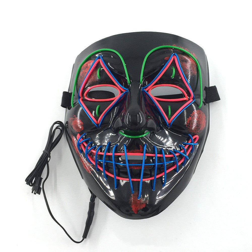 A black LED mask with multicolored neon wires creating a smiling face and symmetrical patterns. It features a cable for power, emphasizing a futuristic or party theme.