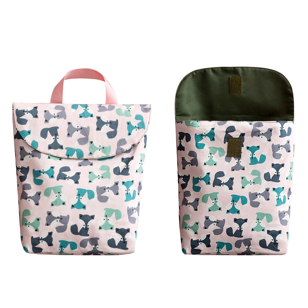 Two pink lunch bags with colorful dog patterns, one closed and one open to reveal a dark green interior. Both have a pink handle and a flap closure.
