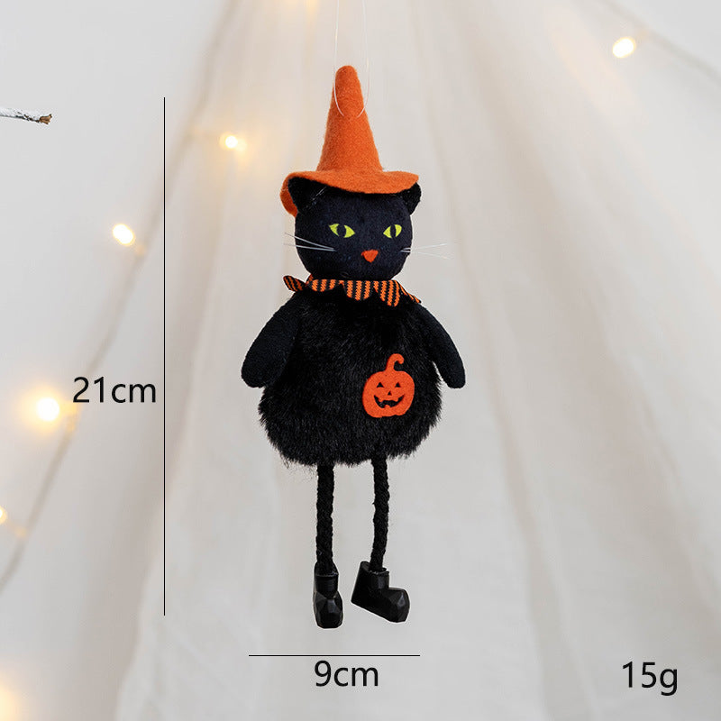 Plush black cat ornament wearing an orange witch hat and striped collar, with a pumpkin design. Measures 21cm tall and 9cm wide, weighs 15g. Hanging against a blurred light background.