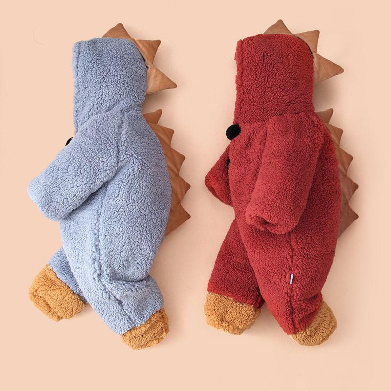 Two plush dinosaur-themed outfits for children, one blue and one red, featuring brown spikes and feet, displayed against a beige background.