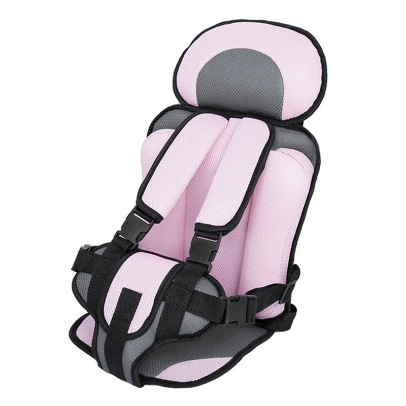 Pink and gray child car seat with cushioned padding and adjustable black straps, designed for comfort and safety.