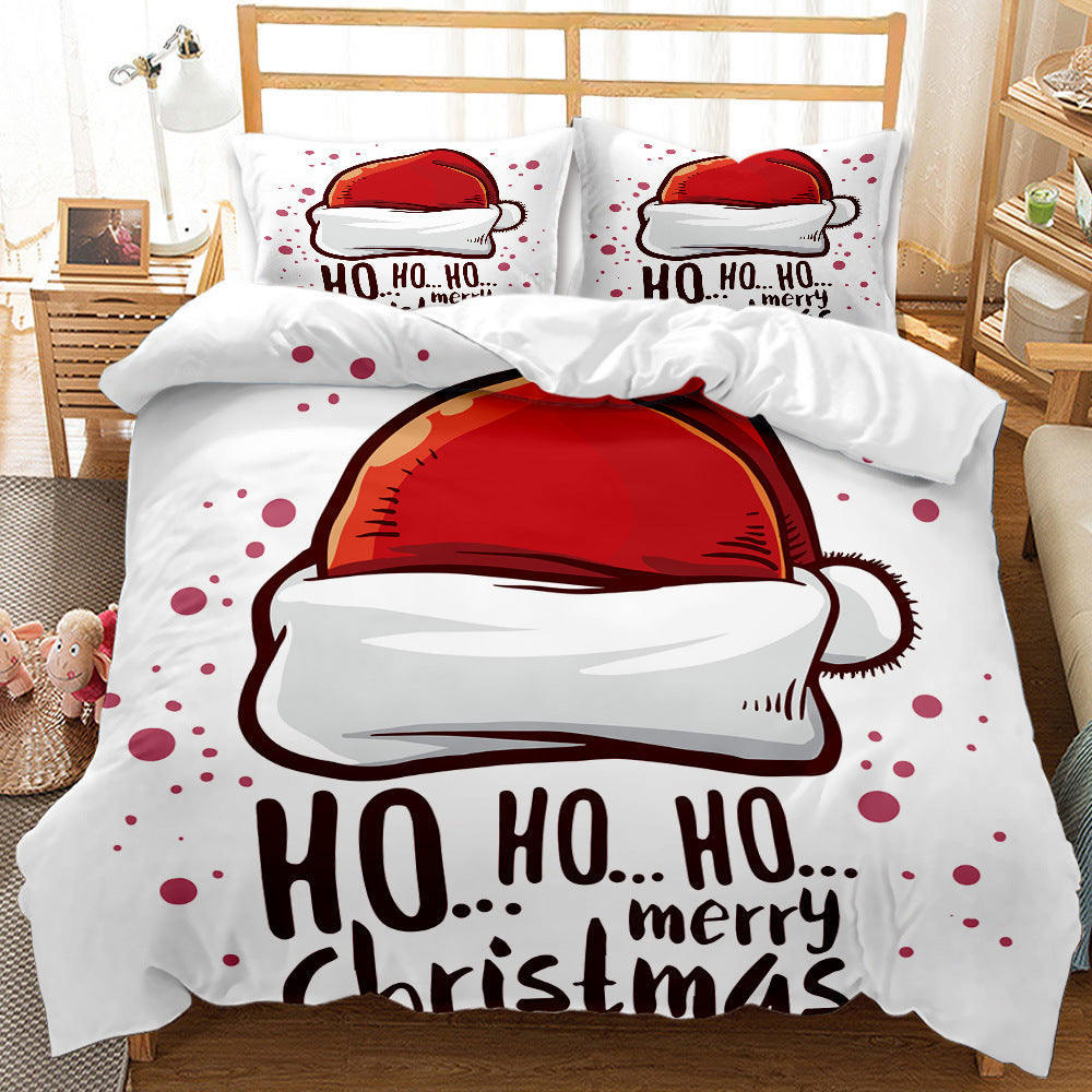 Festive bedding set with Santa hats and "Ho Ho Ho, Merry Christmas" text. Red and white colors dominate, creating a cheerful, holiday atmosphere in the cozy bedroom.