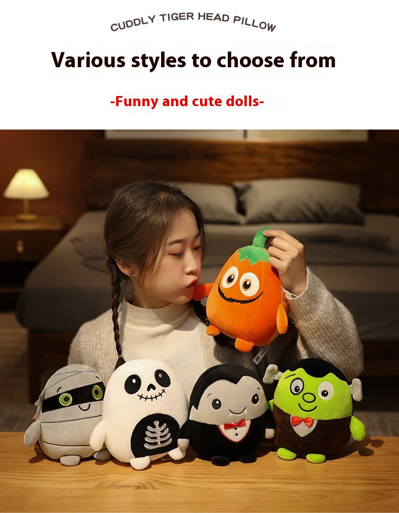 A person holds a cute orange plush toy with four other toys on a table: a mummy, skeleton, vampire, and Frankenstein. Text above reads "Various styles to choose from - Funny and cute dolls."