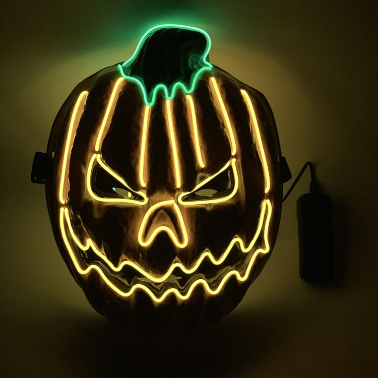 A glowing jack-o'-lantern face outlined in neon lights with a sinister expression, featuring bright yellow lines and a green stem against a dark background.