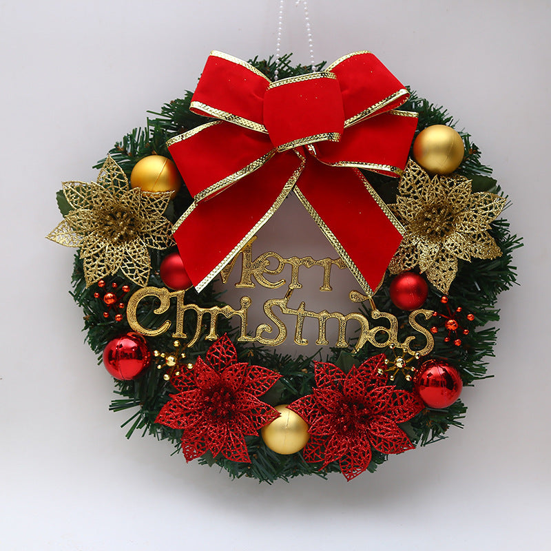 Festive Christmas wreath with a large red bow, golden "Merry Christmas" text, gold and red poinsettias, and shiny baubles set against a backdrop of green pine.
