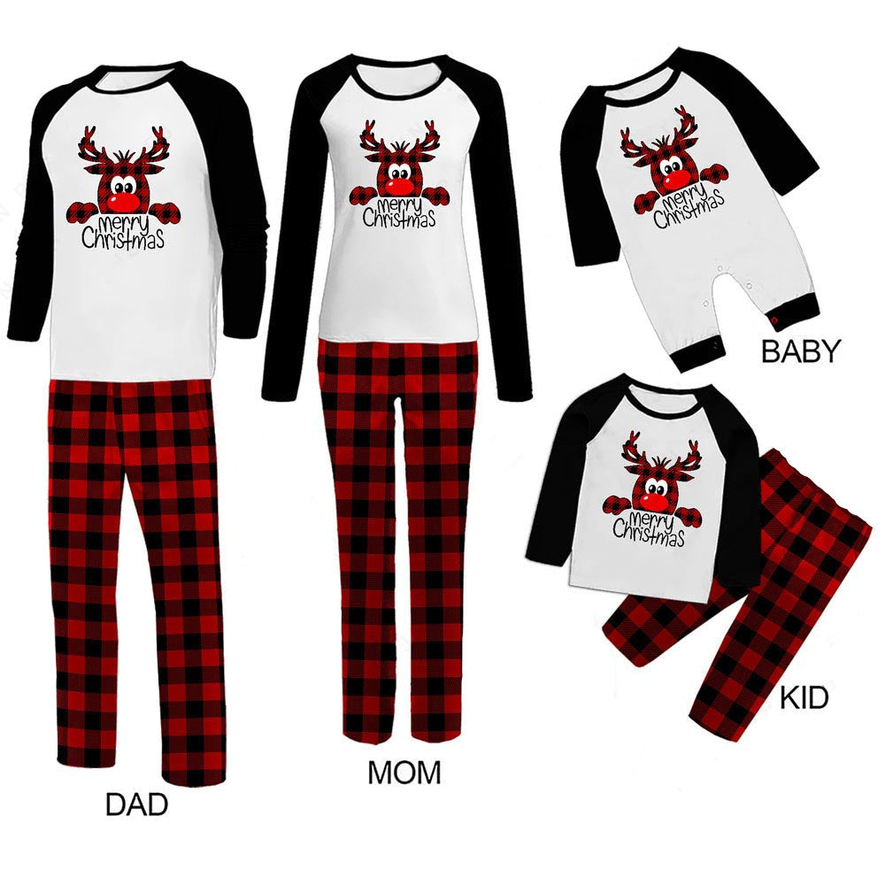 Family Christmas pajamas featuring cartoon reindeer with "Merry Christmas." Matching black and white tops and red checkered pants for dad, mom, kid, and baby onesie.