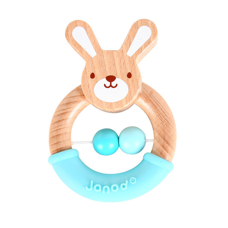 A wooden baby rattle shaped like a bunny with a circular frame, featuring two blue beads and a blue silicone grip. The brand "Janod" is printed on the grip.
