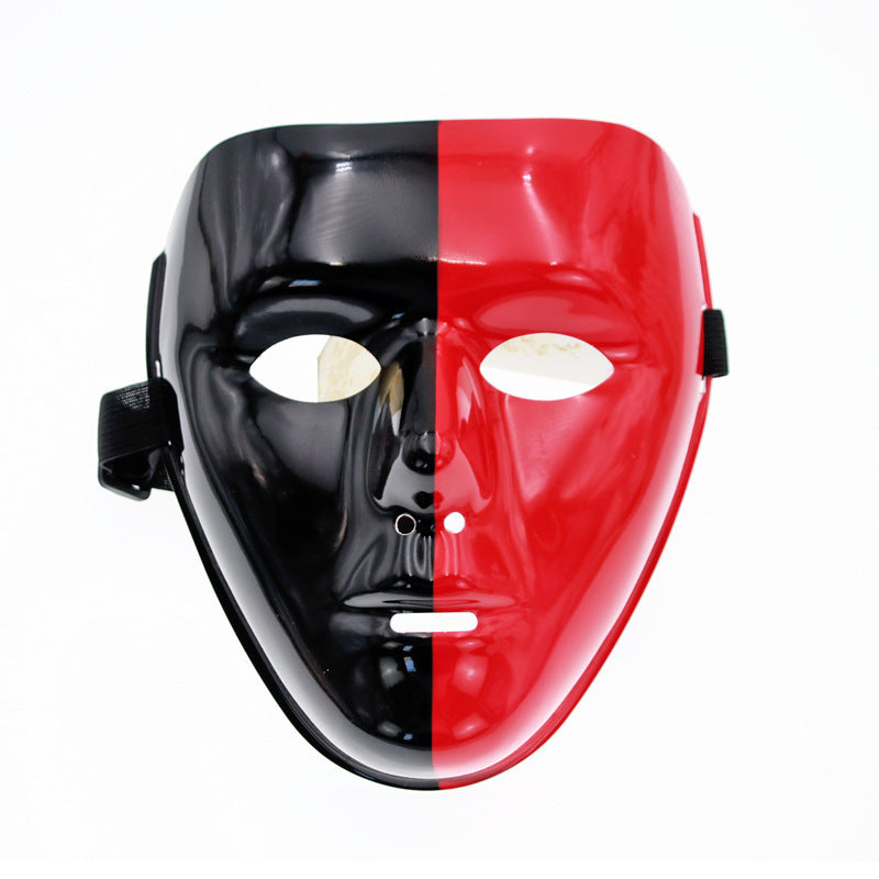 A glossy, split-colored mask with one half black and the other half red, featuring eye and mouth cutouts, secured by a black strap.
