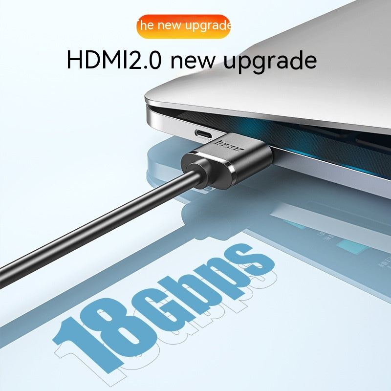 Close-up of an HDMI 2.0 cable plugged into a laptop. Text reads "HDMI2.0 new upgrade" with "18 Gbps" highlighted, emphasizing high data transfer speed.