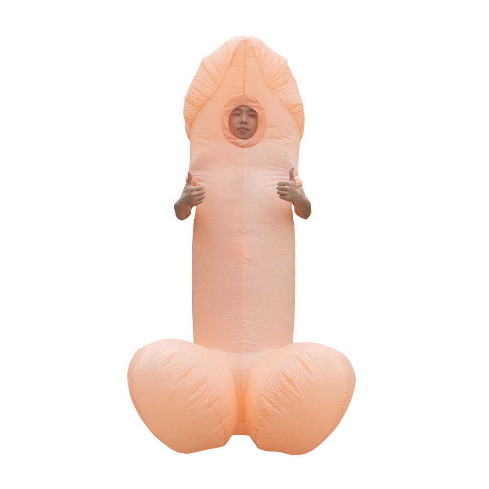A person wearing an inflatable novelty costume resembling a large, anatomically humorous shape. The costume is primarily light pink and features an opening for the face. The individual is giving a thumbs-up gesture. The background is plain white, making the costume the focal point.