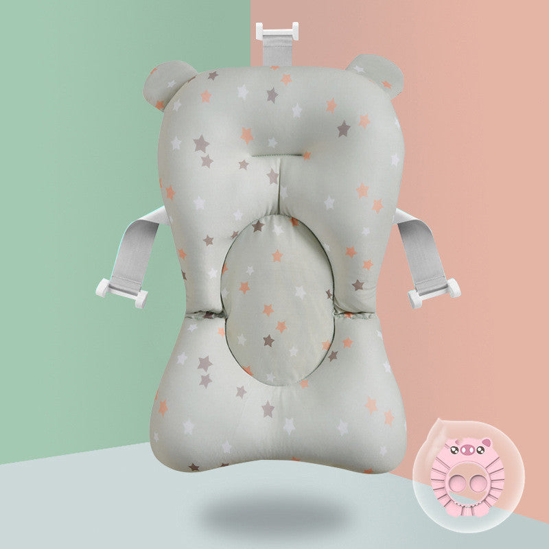 Baby bath seat cushion with bear ears, star pattern, and adjustable straps. Pastel green and pink background, featuring a small pink lion-shaped bath toy in the corner.