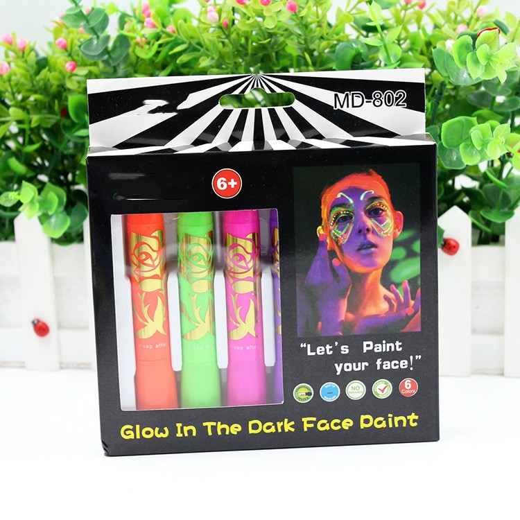 Glow in the Dark Face Paint set for ages 6+, featuring three vibrant colors. Packaging shows a person with neon face designs, prompting, "Let's paint your face!"