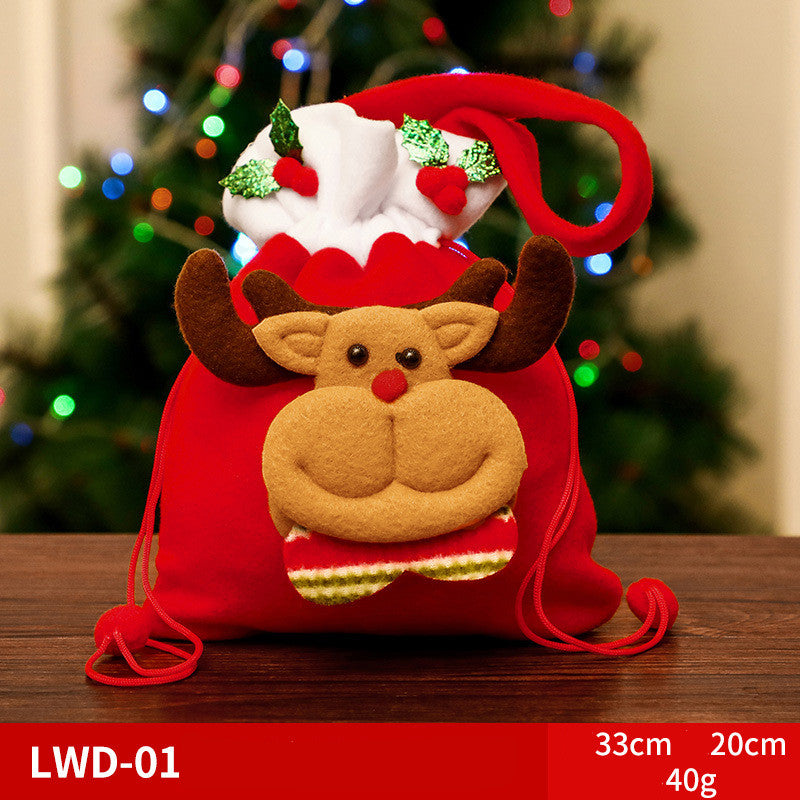 Red Christmas gift bag featuring a plush reindeer design with a red nose and antlers. Topped with white fabric decorated with holly. Measurements: 33cm x 20cm, 40g.