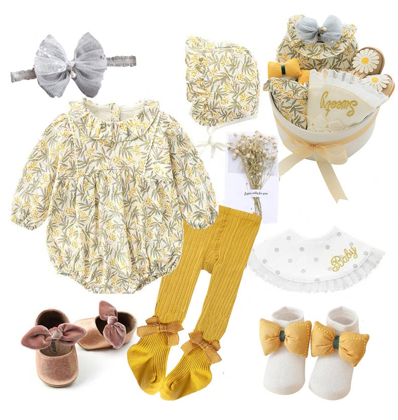 Baby outfit set with floral romper, matching bonnet, mustard tights, brown shoes, white socks, headband, and bib. Includes a gift box with flowers and "sweet" and "baby" decorations.