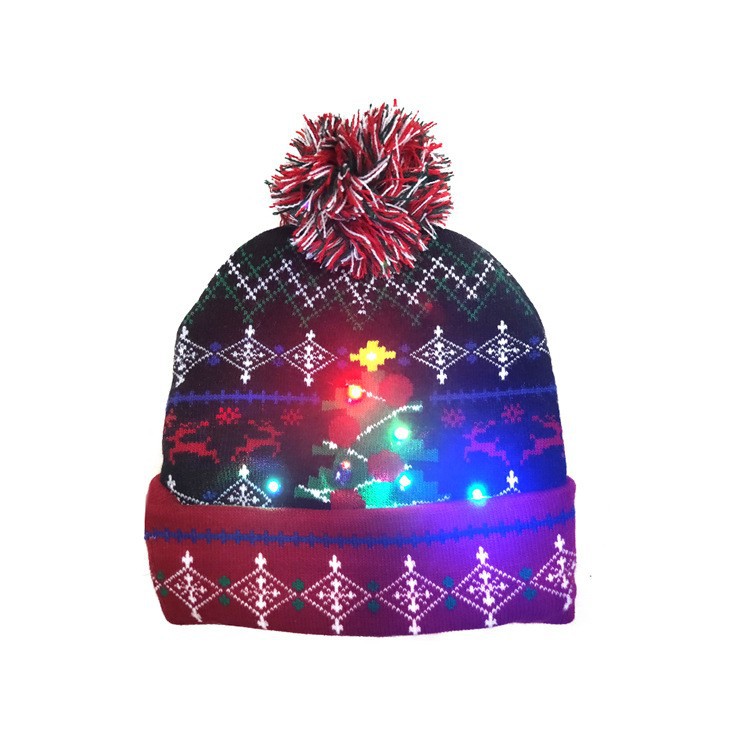Festive knit beanie with a colorful pom-pom and Christmas pattern. It features LED lights shaped like a tree, reindeer, and snowflakes. Perfect for holiday celebrations.