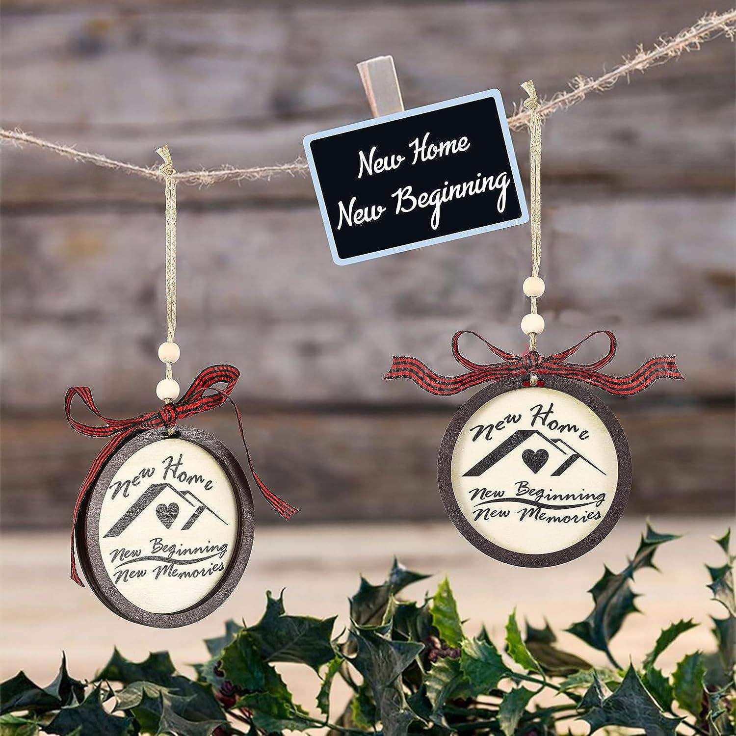 Two round ornaments with red bows hang from twine, each featuring "New Home, New Beginning, New Memories." A small chalkboard sign reads, "New Home, New Beginning."
