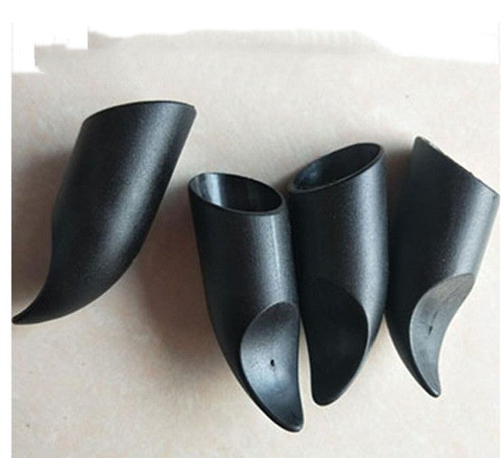 Four black, horn-shaped shoe protectors, designed to cover and shield pointed heels, are arranged on a light surface.