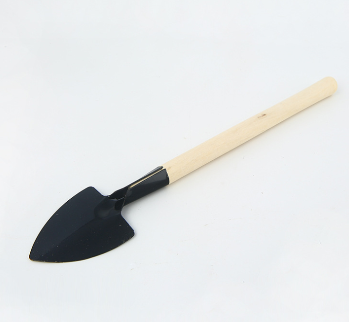 A small garden shovel with a black metal head and a light wooden handle, isolated on a white background.