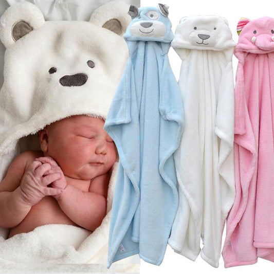 Newborn wearing a bear-themed hooded blanket sleeps peacefully beside three plush animal-themed hooded baby towels in blue, white, and pink.