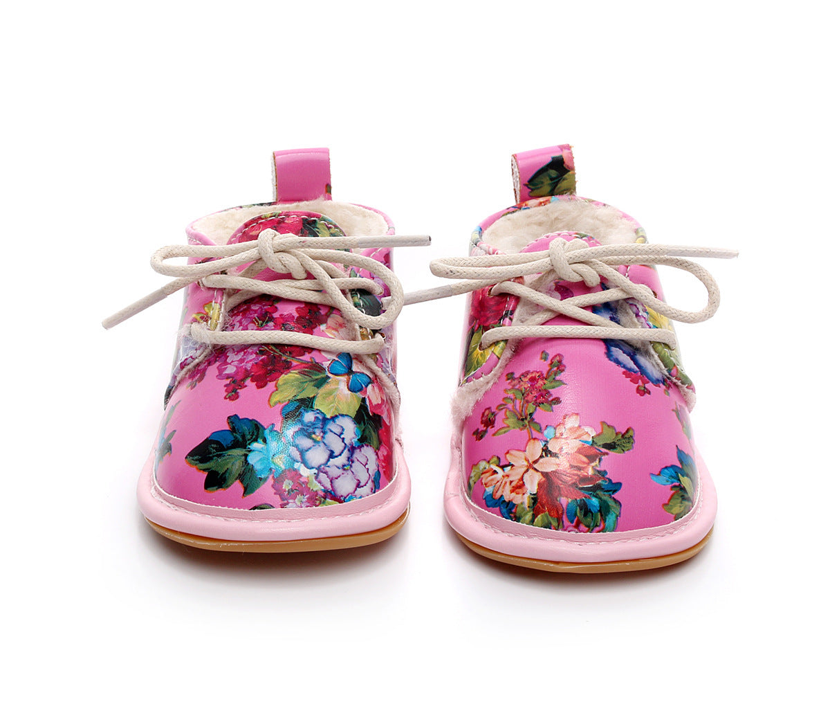 Pink toddler boots with a floral pattern, featuring colorful flowers and white laces. The boots have a soft, woolly lining and rubber soles.