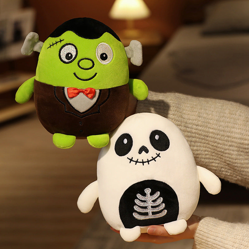 Two plush toys are held. The first is a green monster with a bow tie and stitches, resembling Frankenstein's creature. The second is a white skeleton with a ribcage design.