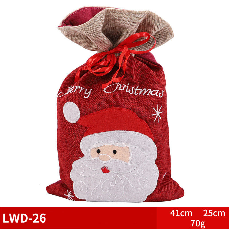 Red Christmas gift bag with a Santa Claus design and "Merry Christmas" text. Tied with a red ribbon. Dimensions are 41cm by 25cm, weighing 70g. Model LWD-26.