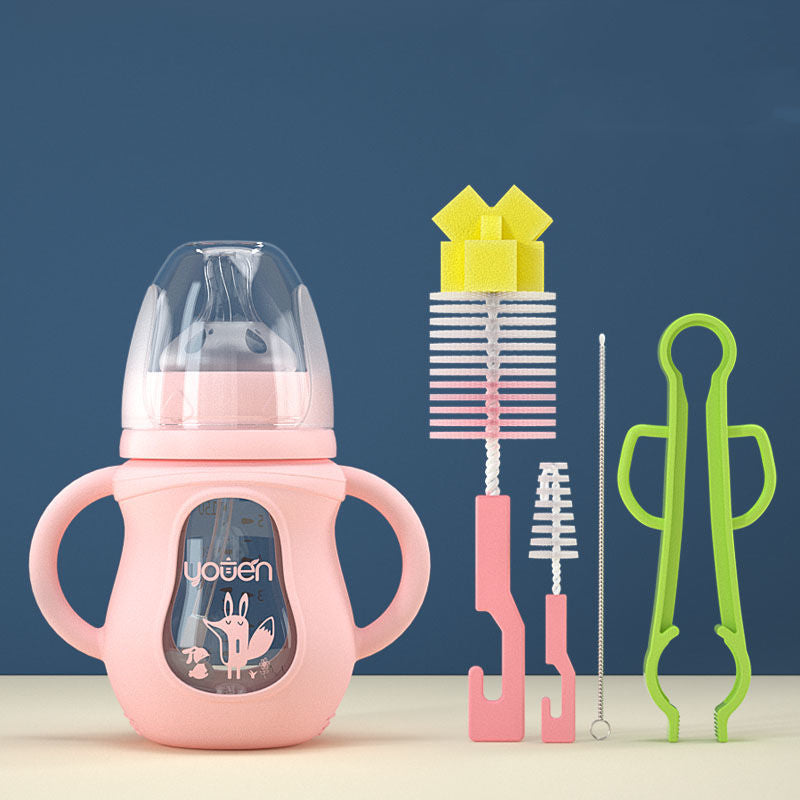 Pink child's sippy cup with dual handles and a clear lid, featuring a fox design. Accompanied by various cleaning brushes and a green tong against a blue background.
