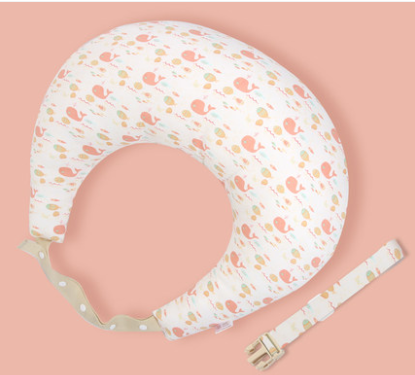 Baby neck pillow with a cute pink whale pattern on a soft peach background, featuring a detachable strap with a clasp, designed for comfortable support.