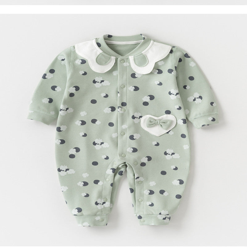 Light green baby onesie with white collar and polka dots featuring sheep prints. Includes a heart-shaped pocket with a bow on the front.