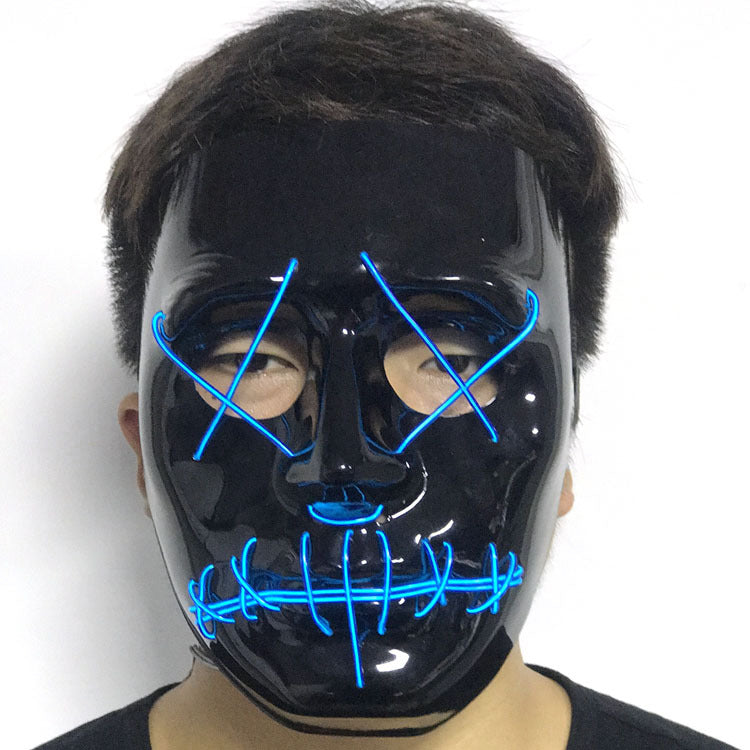 Person wearing a glossy black mask with glowing blue wire patterns over the eyes and mouth, resembling stitched lines, creating a mysterious appearance.