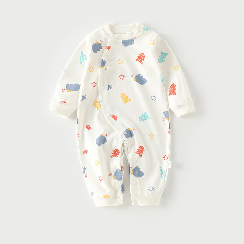 Baby onesie with colorful prints of bears, trees, and shapes on a white background. It has long sleeves, snap buttons down the front, and a round neckline.