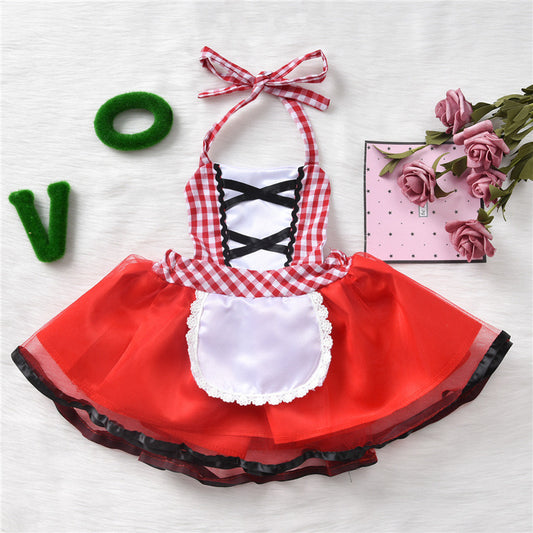 A red and white checkered halter dress with black lace detail and white apron, placed beside green letters and pink roses on a decorative box.