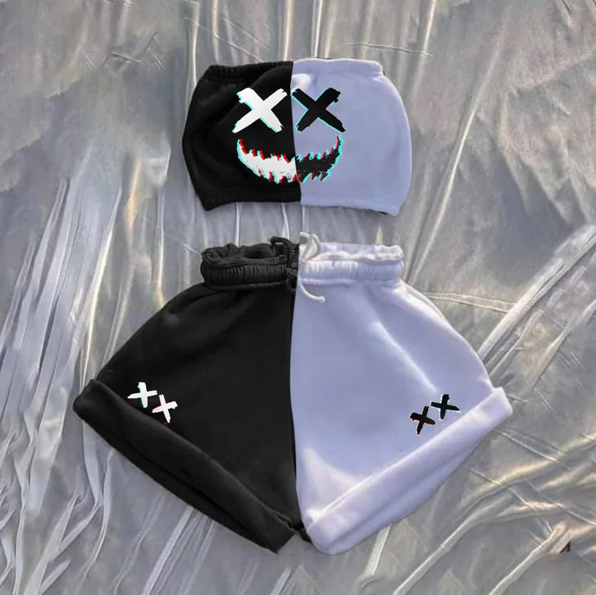 Two-piece outfit on a textured background. The top is half black, half white with an evil smile and "X" eyes design. The shorts are similarly divided, with "XX" on each side. The overall design features a monochrome theme with a playful yet edgy look.