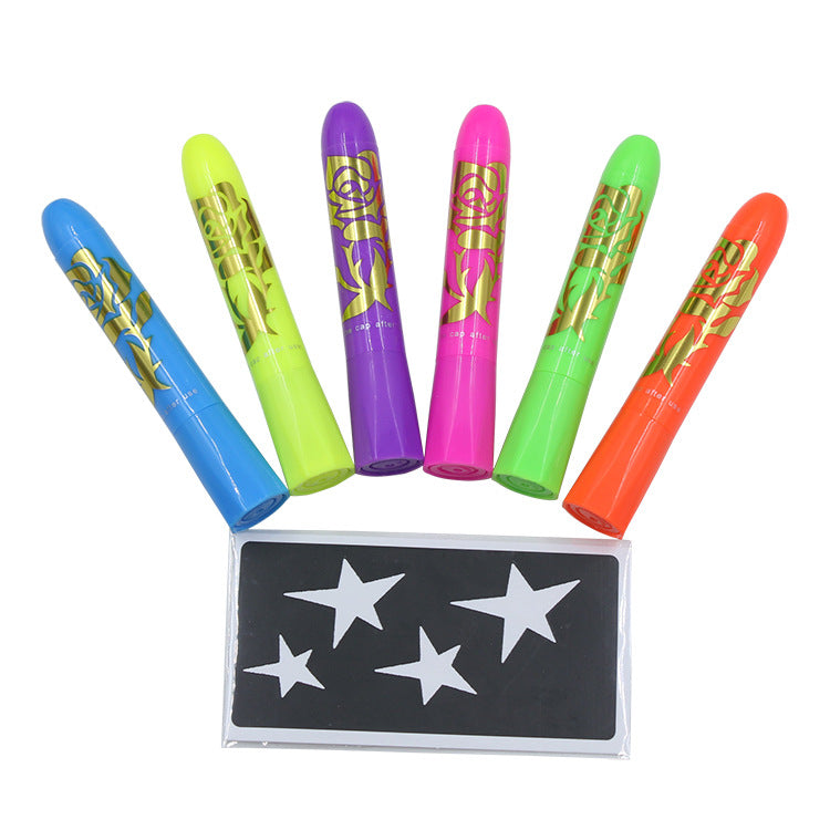 Six colorful bottles with gold designs are lined up in a semicircle above a sheet of star-shaped stencils. The bottles are blue, yellow, purple, pink, green, and orange.