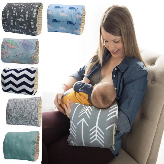 A woman uses a breastfeeding pillow with arrow patterns to nurse her baby. Six pillow designs are displayed on the left, including fish, whales, leaves, chevron, floral, and geometric patterns.