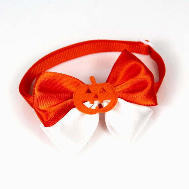 Orange and white bow tie with a pumpkin decoration in the center, secured on a matching orange elastic band, perfect for Halloween-themed attire.