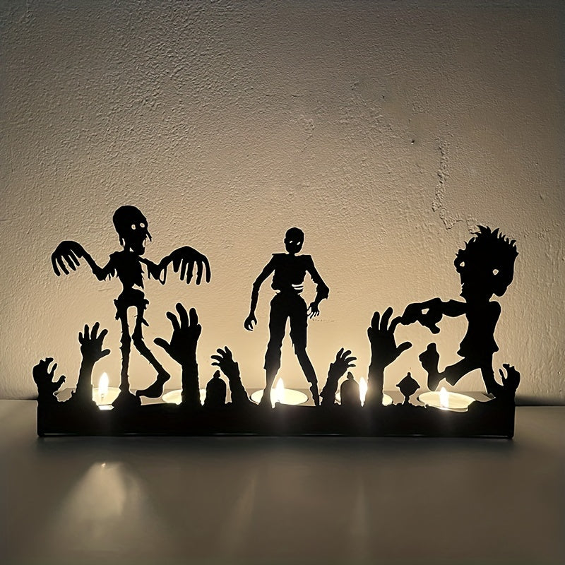 Silhouette of Halloween-themed zombie figurines with raised hands, backlit by candlelight, creating an eerie glow against a plain wall.