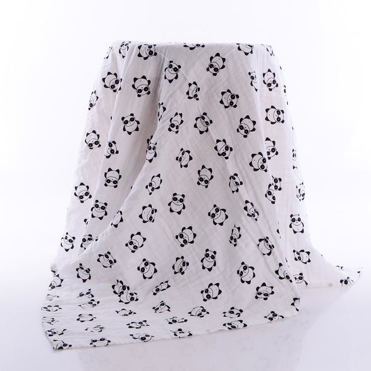 White muslin blanket draped over an object, featuring a cute panda pattern in black. The pandas are evenly spaced, adding a playful touch to the soft fabric.