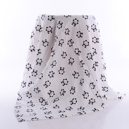 White muslin blanket draped over an object, featuring a cute panda pattern in black. The pandas are evenly spaced, adding a playful touch to the soft fabric.