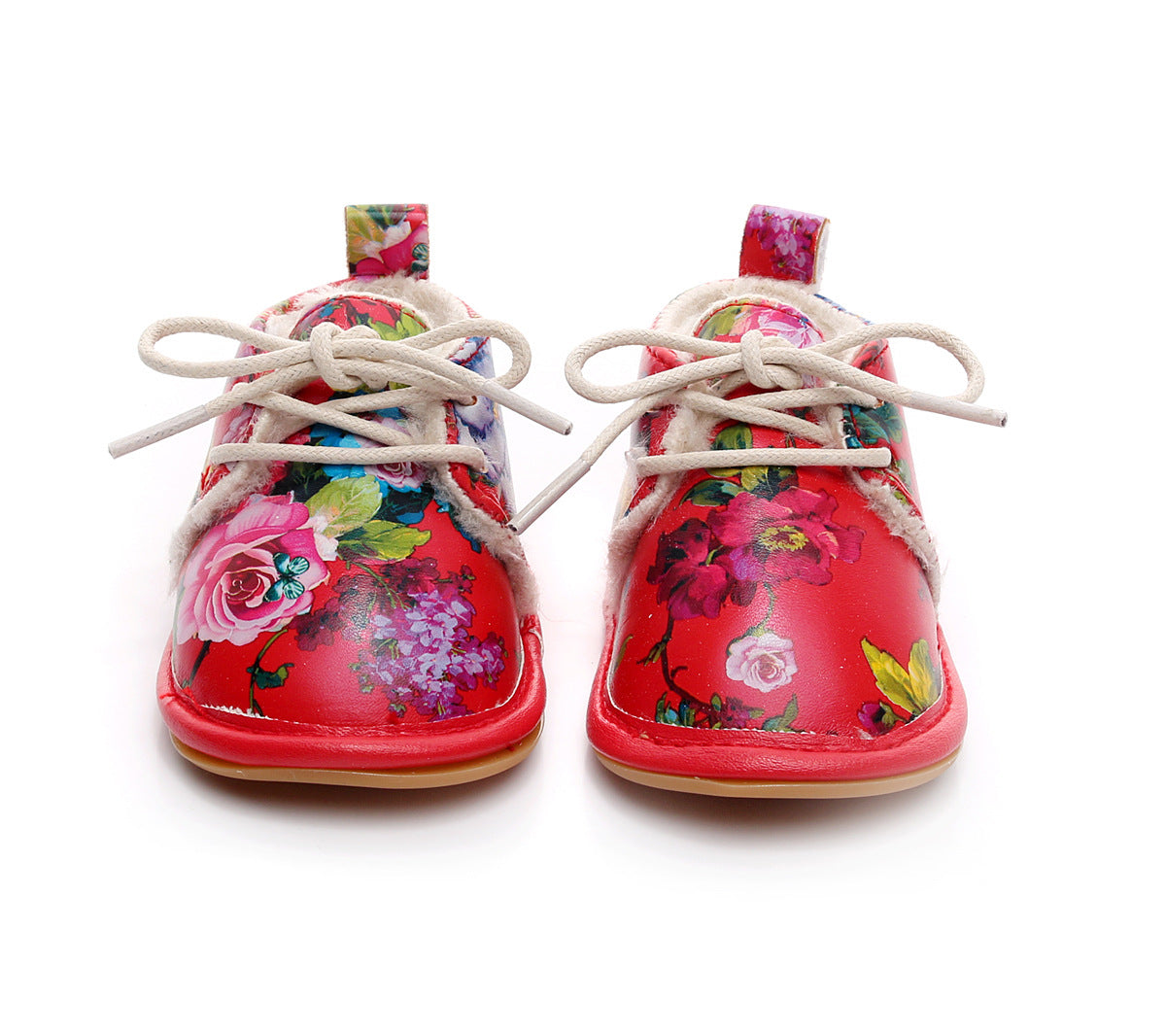 Bright red children's shoes with multicolored floral patterns, white laces, and a soft lining. The vibrant design features roses and various other flowers on both shoes.