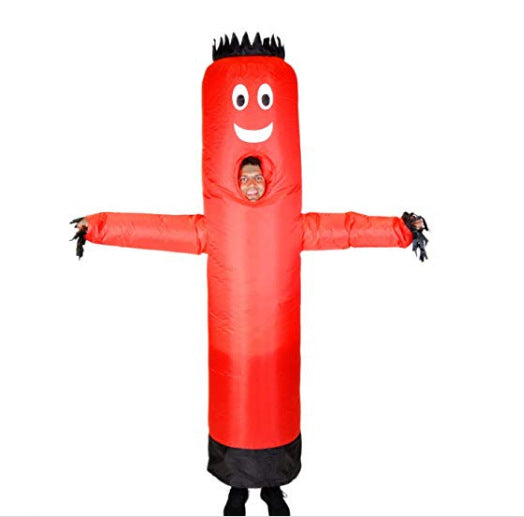 Person in an inflatable red tube man costume with a smiling face and black hair-like fringe, extending arms to the sides. The face of the person is visible through a cutout.