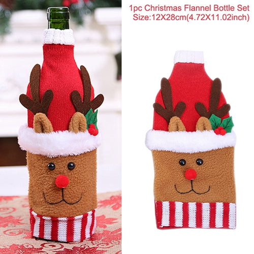 Festive bottle cover shaped like a reindeer with antlers, red nose, and Santa hat. Set on a table, it's designed for Christmas decor. Set size: 12x28cm (4.72x11.02 inches).