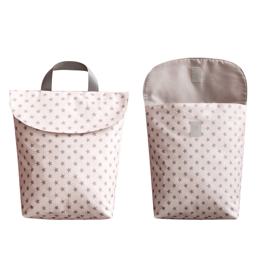 Two pink fabric lunch bags with small gray star patterns. One is closed with a handle, and the other is open, revealing a Velcro closure.