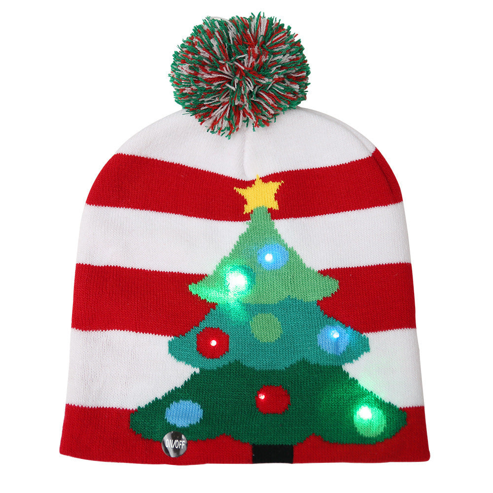 Festive beanie with red and white stripes, featuring a decorated Christmas tree with lit-up ornaments, a yellow star, and a red-green pom-pom on top.
