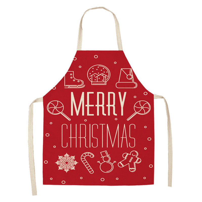 Red apron with "Merry Christmas" text, featuring white line drawings of festive symbols like a snowflake, candy cane, snowman, gingerbread man, and lollipops.