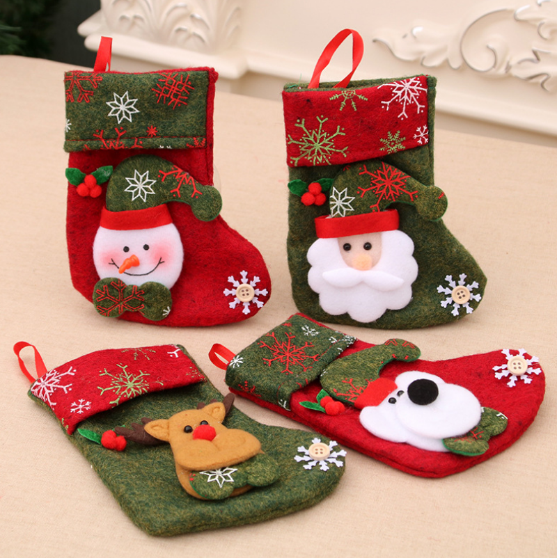 Four festive Christmas stockings featuring a snowman, Santa, reindeer, and polar bear design. Each stocking is decorated with snowflakes, buttons, and red and green felt.